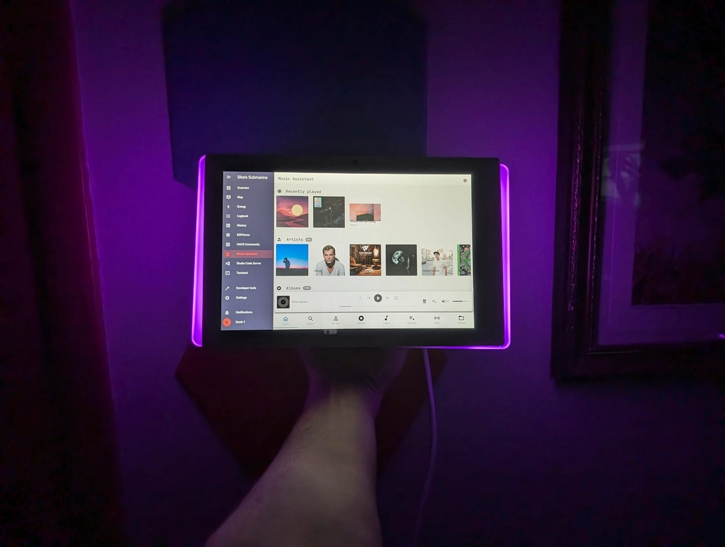Nightmode Music Assistant! A really poor quality "glamour" shot at night of what the device could look like with the LEDs on and some music playing. The room is dark and the LEDs are giving off a strong purple/magenta color.